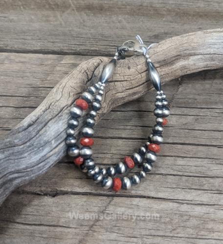 Bracelet: dbl strand Navajo pearl w/ red cora by Myra Gadson